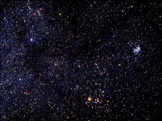 Photo of blue, red, and yellow stars on a black background. Constellation Taurus